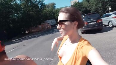 Naked girl on a motorcycle. Topless in the city