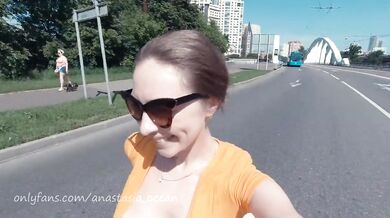 Naked girl on a motorcycle. Topless in the city