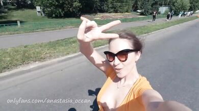 Naked girl on a motorcycle. Topless in the city