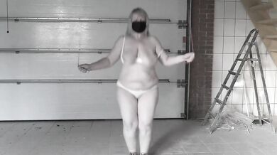 A mature bbw milf with a hairy pussy and big saggy natural tits is jumping rope.