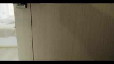 LanaYoung in a latex suit satisfies a customer in a hotel room.