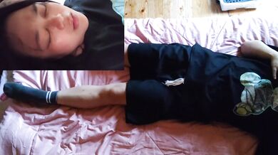 A Japanese woman masturbating with a sloppy expression.