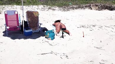SHOWING BUTT PLUG ON THE BEACH
