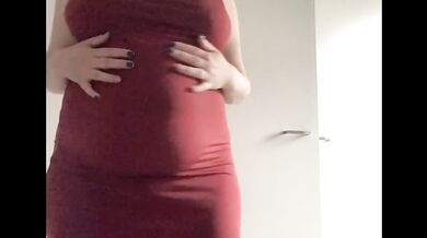 Round fat belly in a red dress