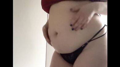 Round fat belly in a red dress