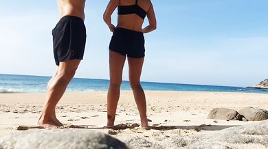 Fitness couple undress on a public beach and masturbate with people watching