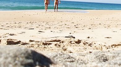 Fitness couple undress on a public beach and masturbate with people watching