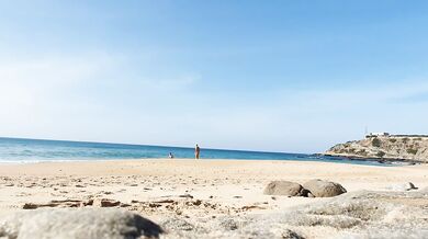 Fitness couple undress on a public beach and masturbate with people watching