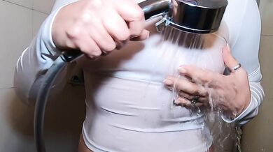 In the shower in a white T-shirt