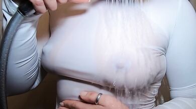 In the shower in a white T-shirt
