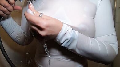 In the shower in a white T-shirt