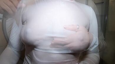 In the shower in a white T-shirt