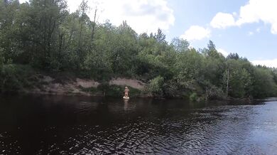 Naked girl on a hiking trip on a SUP board