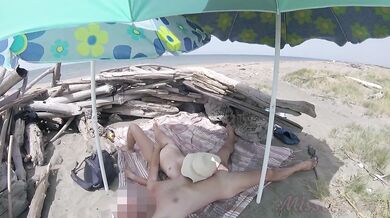 On a nudist beach in Tenerife, the stepdaughter jerks off her stepfather's cock without shame