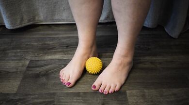 Foot massage with a hedgehog ball