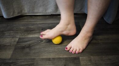 Foot massage with a hedgehog ball