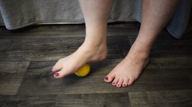 Foot massage with a hedgehog ball