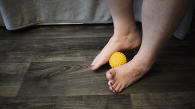 Foot massage with a hedgehog ball