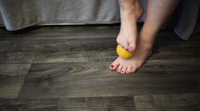 Foot massage with a hedgehog ball